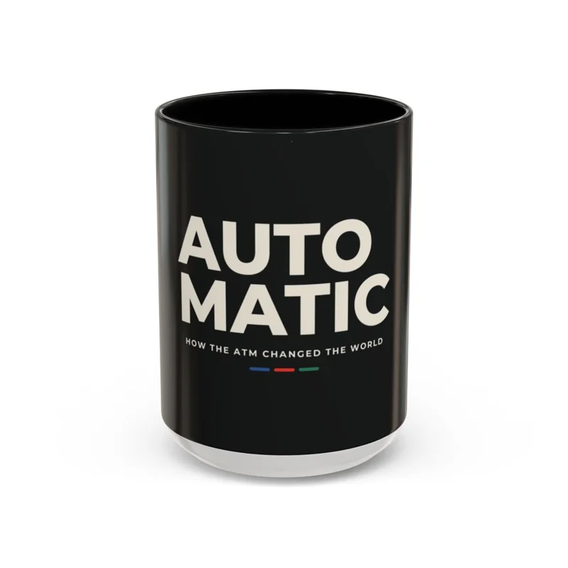 A black mug printed with the AUTOMATIC title in cream.